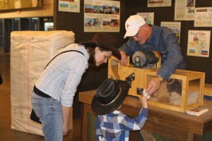 If your fair has a Texas Farm Bureau booth, be sure to stop by! This family is learning about our mini cotton gin. 